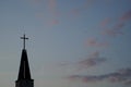 Silhouettes of Catholic Christian church steeple and flying birds on twilight sky in Bucharest Royalty Free Stock Photo