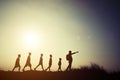 Silhouettes children and parent walking with backpacks. Time to Royalty Free Stock Photo