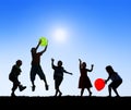 Silhouettes of Children Playing Balloons Outdoors Royalty Free Stock Photo