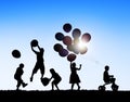 Silhouettes of Children Playing Balloons and Riding Bicycle Royalty Free Stock Photo