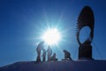 Silhouettes of children playing and riding on a snow slide, copy space