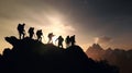 Silhouettes of climbers reach mountain\'s peak through teamwork and mutual assistance