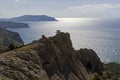 Silhouettes of coastal mountains against the background of the s