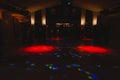 Silhouettes of concert crowd in front of bright stage lights. Disco and nightlife concept