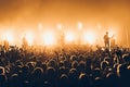 Silhouettes of concert crowd in front of bright stage lights. A sold out crowd on rock concert. Crowd of fans at music festive. Pa Royalty Free Stock Photo