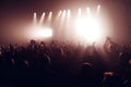 Silhouettes of concert crowd in front of bright stage lights. Unrecognized people in crowd. Copy space background. Crowd of fans a Royalty Free Stock Photo