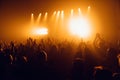 Silhouettes of concert crowd in front of bright stage lights. Unrecognized people in crowd. Copy space background. Crowd of fans a Royalty Free Stock Photo