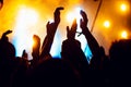 Silhouettes of concert crowd in front of bright stage lights. Unrecognized people in crowd. Copy space background. Crowd of fans a Royalty Free Stock Photo