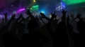 Silhouettes of concert crowd with hands raised at a music disco Royalty Free Stock Photo