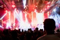 Silhouettes of concert and people crowd in front of bright stage lights. Royalty Free Stock Photo