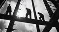 Silhouettes of Construction Workers on a Steel Beam Royalty Free Stock Photo