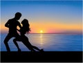 Silhouettes of couple dancing. Sunset on the background. Royalty Free Stock Photo