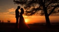 Silhouettes of a couple in love at sunset. As the sun sets on Valentine& x27;s Day, couples are silhouetted hugging