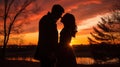 Silhouettes of a couple in love at sunset. As the sun sets on Valentine& x27;s Day, couples are silhouetted hugging