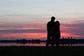 Silhouettes of a couple in love watching the summer sunset Royalty Free Stock Photo