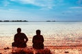 Silhouettes of a couple are sitting on the bank of the river. Pop Art. Postprocessing Royalty Free Stock Photo