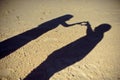 Silhouettes of couple or two lovers photography together, Shadow on the Ground, Woman gesture a heart-shaped arm, Concept of roman