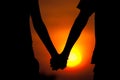 Silhouettes couples hands on sunset