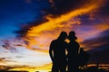 Silhouettes couples with sunset