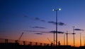 Silhouettes of cranes in the harbor at sunset Royalty Free Stock Photo