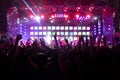 Silhouettes of crowd, group of people, cheering in live music concert in front of colorful stage lights Royalty Free Stock Photo