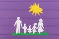 The silhouettes cut out of paper of man and woman with two girls and boy on the grass under the sun Royalty Free Stock Photo