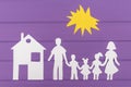 The silhouettes cut out of paper of man and woman with two girls and boy under the sun, house near Royalty Free Stock Photo