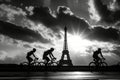 Silhouettes of cyclists against Eiffel Tower with piercing sunrays.