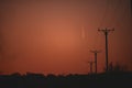 Silhouettes of electricity poles at sunset. Renewable energy Royalty Free Stock Photo