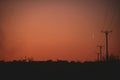 Silhouettes of electricity poles at sunset. Renewable energy Royalty Free Stock Photo