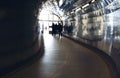 Silhouettes at the end of a tunnel for pedestrians and cyclists