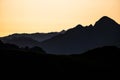 Silhouettes of the Fagaras Mountains at sunrise. The Mount Tarata