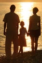Silhouettes of family against glossing sea Royalty Free Stock Photo