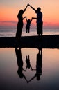 Silhouettes of family against sea decline