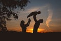 Silhouettes of family at sunset