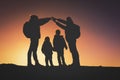 Silhouettes of family with two kids hiking at sunset Royalty Free Stock Photo