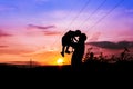 Silhouettes of father and son sunset background