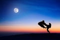 Silhouettes of fighters on background of full moon