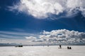 Silhouettes of fishermen fishing and snowmobile in winter on the ice