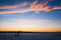 Silhouettes of fishermen on winter fishing on the ice of the river Royalty Free Stock Photo