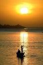 Silhouettes of fishing canoe on Niger River