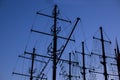 Silhouettes of frigate masts against the blue sky in the evening. Mast yacht at dusk. Masts of a pirate ship in the dark. Gradient Royalty Free Stock Photo