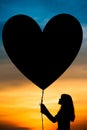 Silhouettes of a girl and balloon Royalty Free Stock Photo