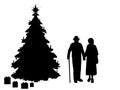 Silhouettes grandparents by the christmas tree. Christmas holiday