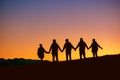 Silhouettes group of friends together at sunset