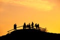 Silhouettes of a group of people at sunset in a park