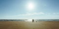 The silhouettes of a group of people walking at the beach