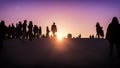 Silhouettes of group of people watching the sunset together Royalty Free Stock Photo