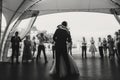 Silhouettes of happy bride and groom gently dancing at wedding reception. Gorgeous wedding couple of newlyweds embracing while Royalty Free Stock Photo