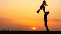 Silhouettes of happy child rushes into hands of father. Royalty Free Stock Photo